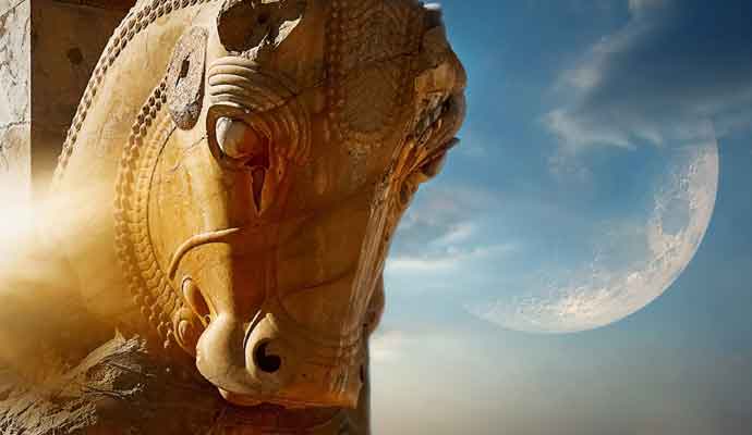 Sculpture of a horse in Persepolis against a blue sky and moon. Iran.