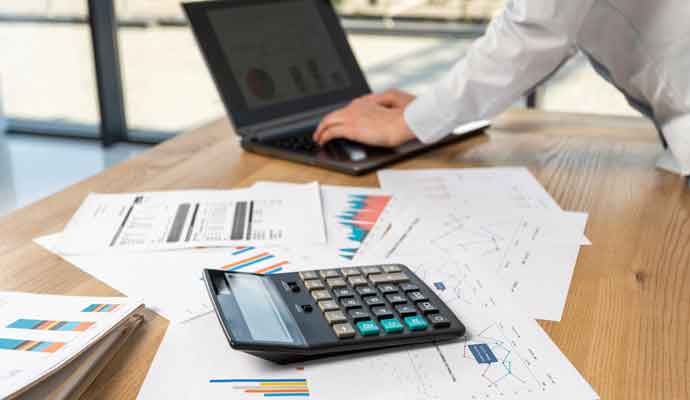 calculator and papers spread on table