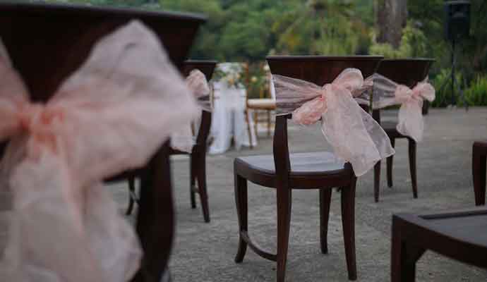chairs arranged for social distancing with pink bows