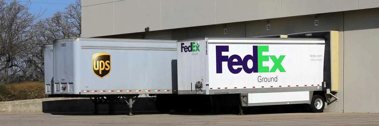 UPS and Fedex trailers parked next to each other