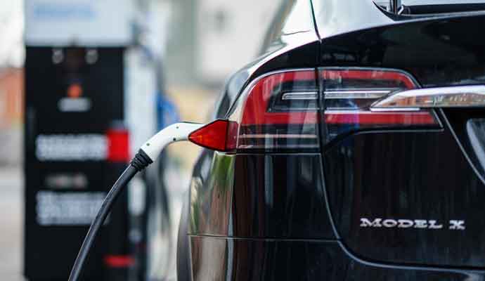 Electric Car Tesla Model X is charging on street charge