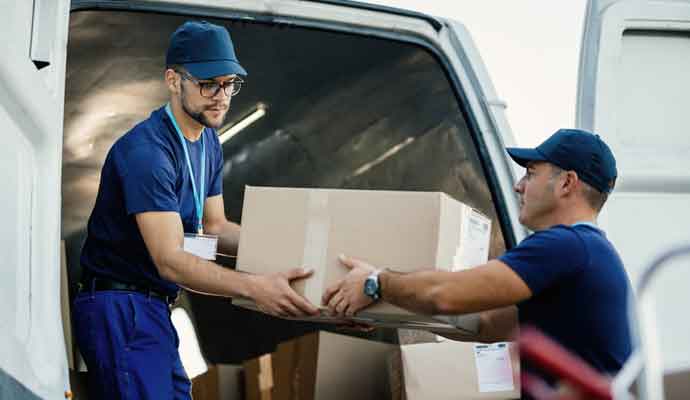 men loading boxes in a van for same day couriers