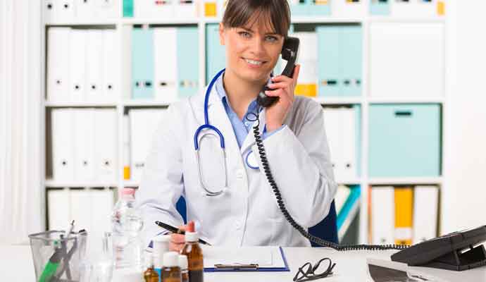 doctor at desk with phone for for UK Same Day Couriers