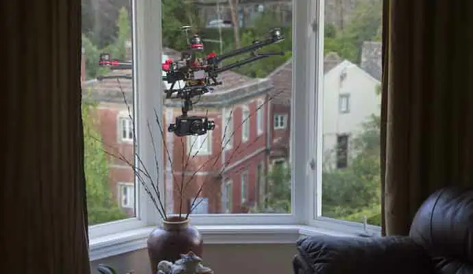  a courier services near me? A drone with a camera hovering outside living-room window
