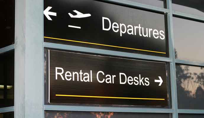 air departures and car rental sign