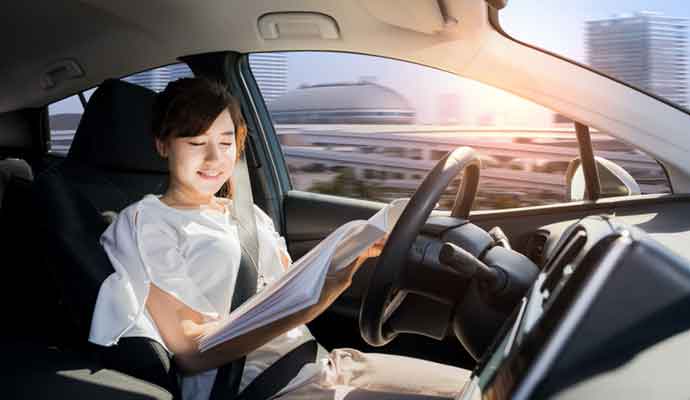 young woman reading a magazine in self driving car